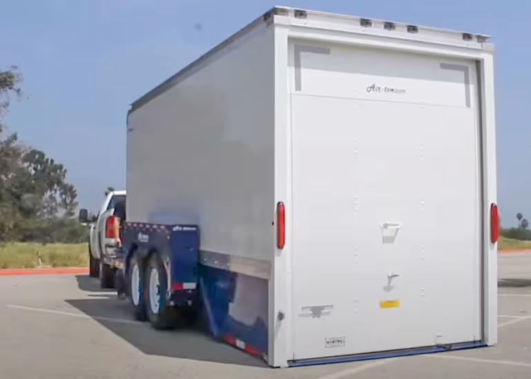 Air-Tow E16 XL enclosed trailer rear view hitched to truck in Canada