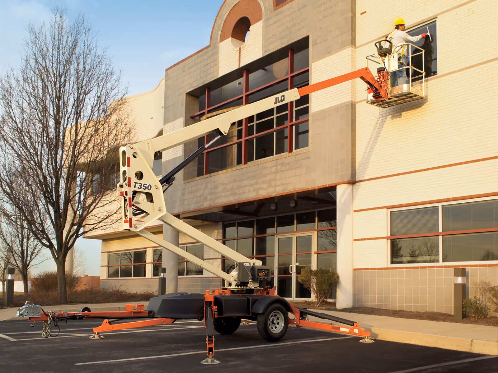 JLG T350 elevated for exterior maintenance on multi-story building in Canada
