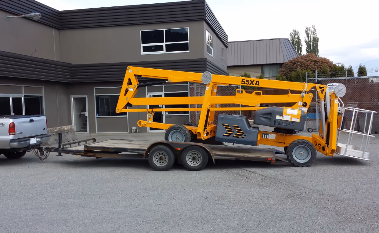 Haulotte 55XA boom lift loaded on trailer for transport in Canada
