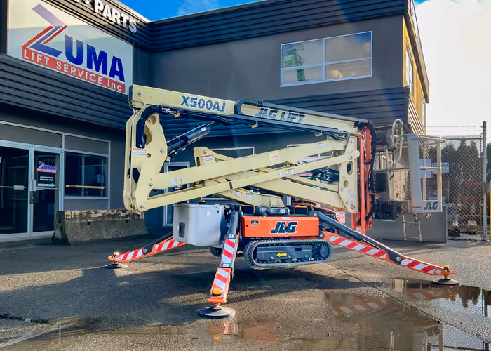 JLG X500AJ articulating crawler boom lift deployed with outriggers on pavement in Canada