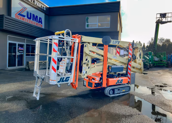 Rear view of a JLG X500AJ articulating crawler boom lift in its stowed travel position at Zuma Lift Service.