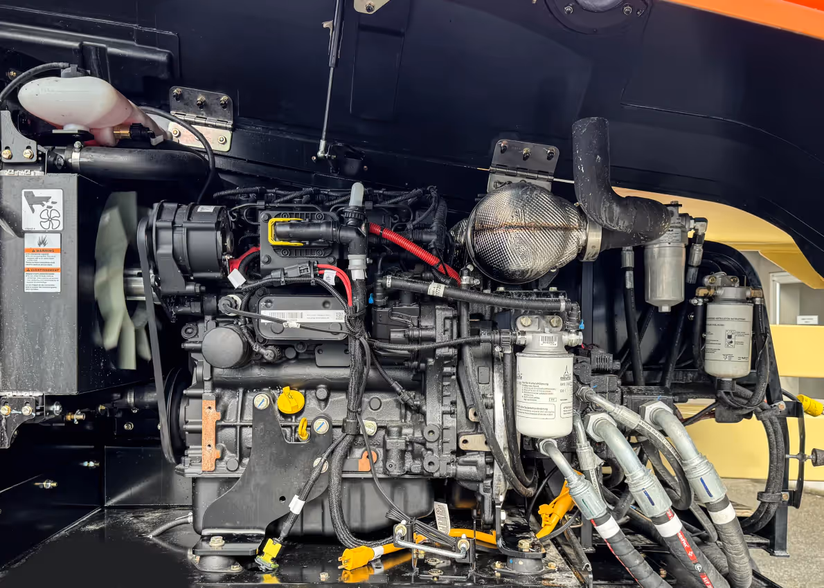 JLG 450AJ articulating boom lift engine compartment showing diesel components in Canada