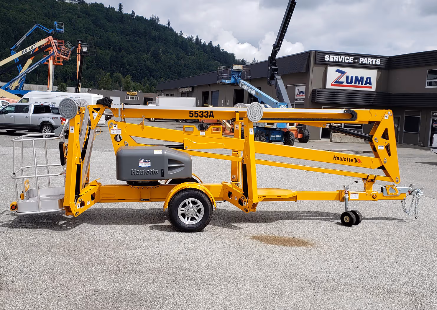 Haulotte 5533A boom lift full left side view with outriggers retracted in Canada