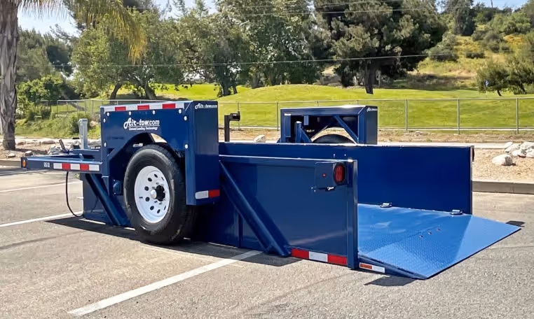 Air Tow US12-55 hydraulic drop-deck trailer fully lowered, ready for loading.