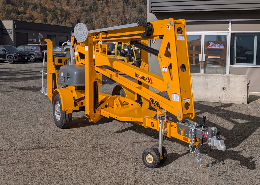 Haulotte 4527A towable boom lift side profile stowed with boom in Canada