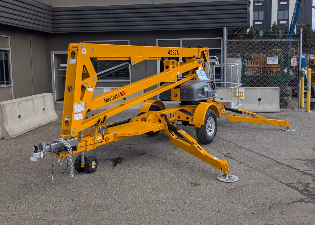 Haulotte 4527A towable boom lift front view with outriggers in Canada