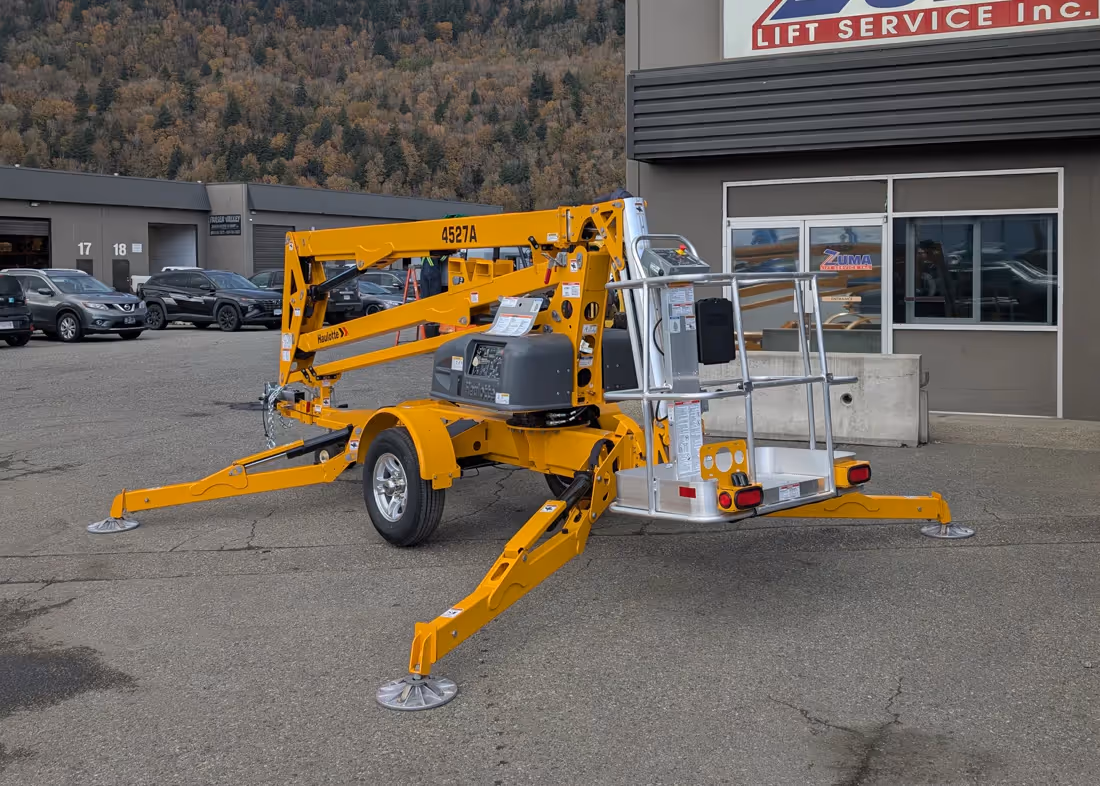 Haulotte 4527A towable boom lift rear view with outriggers in Canada