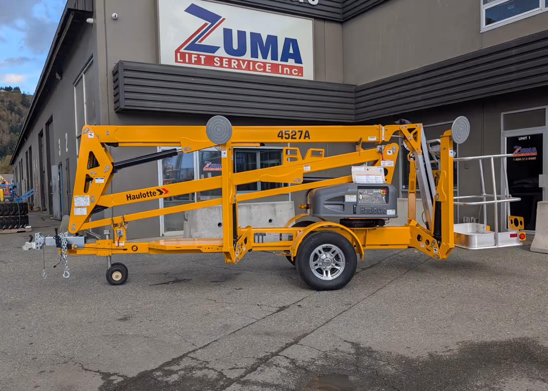 Haulotte 4527A towable boom lift side view stowed at Zuma in Canada