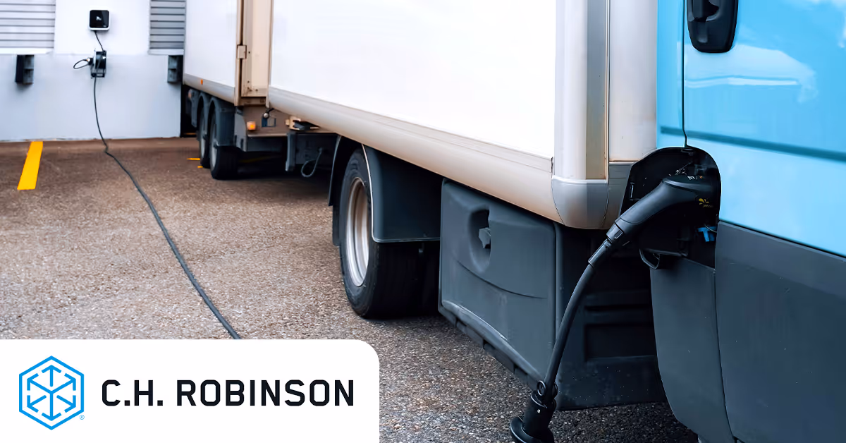 close up of an electric freight truck charging and the logo for C H Robinson