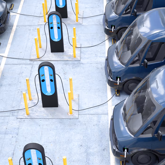 light of work vans parked and plugged into electric chargers