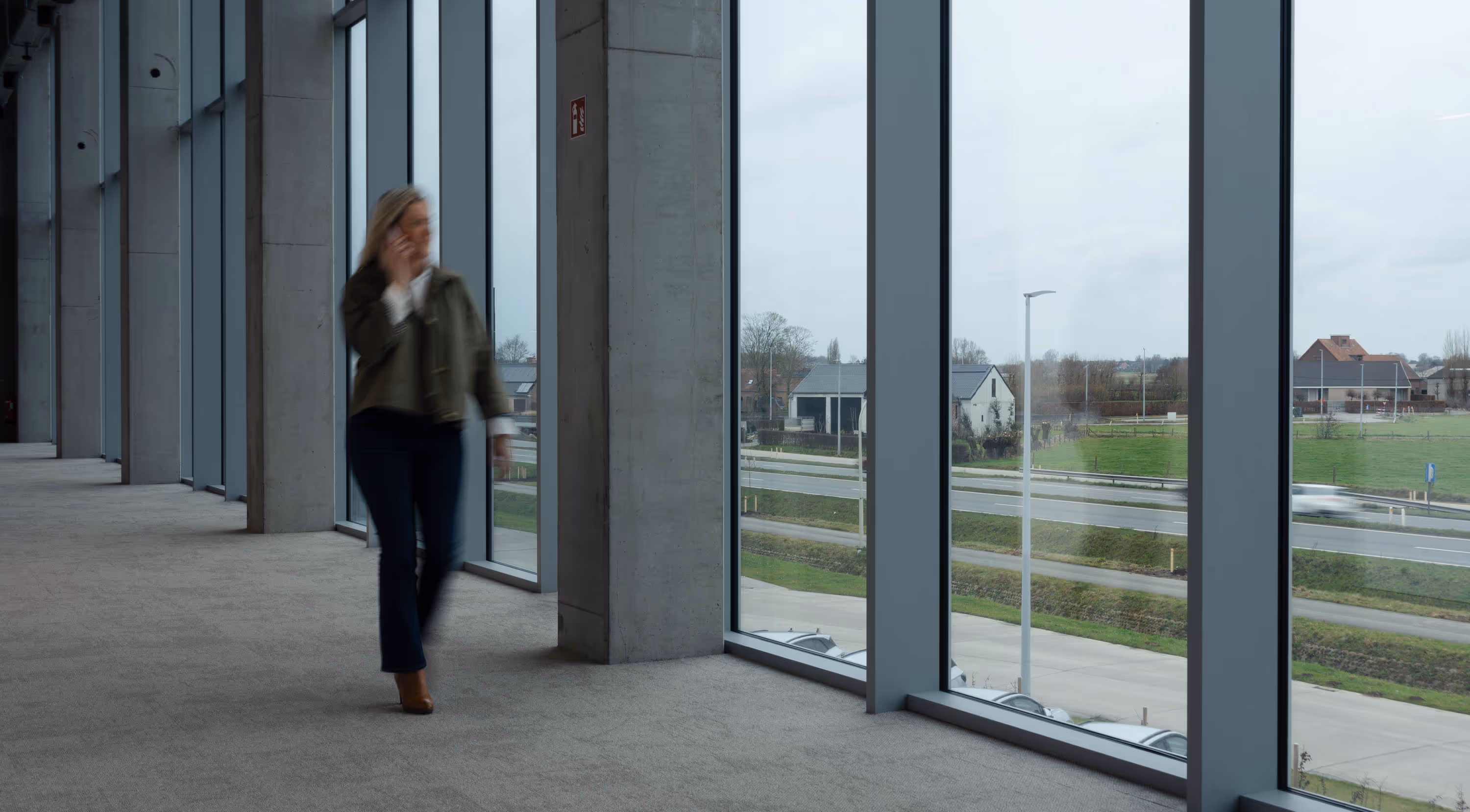 A lady talking on mobile and walking on corridor