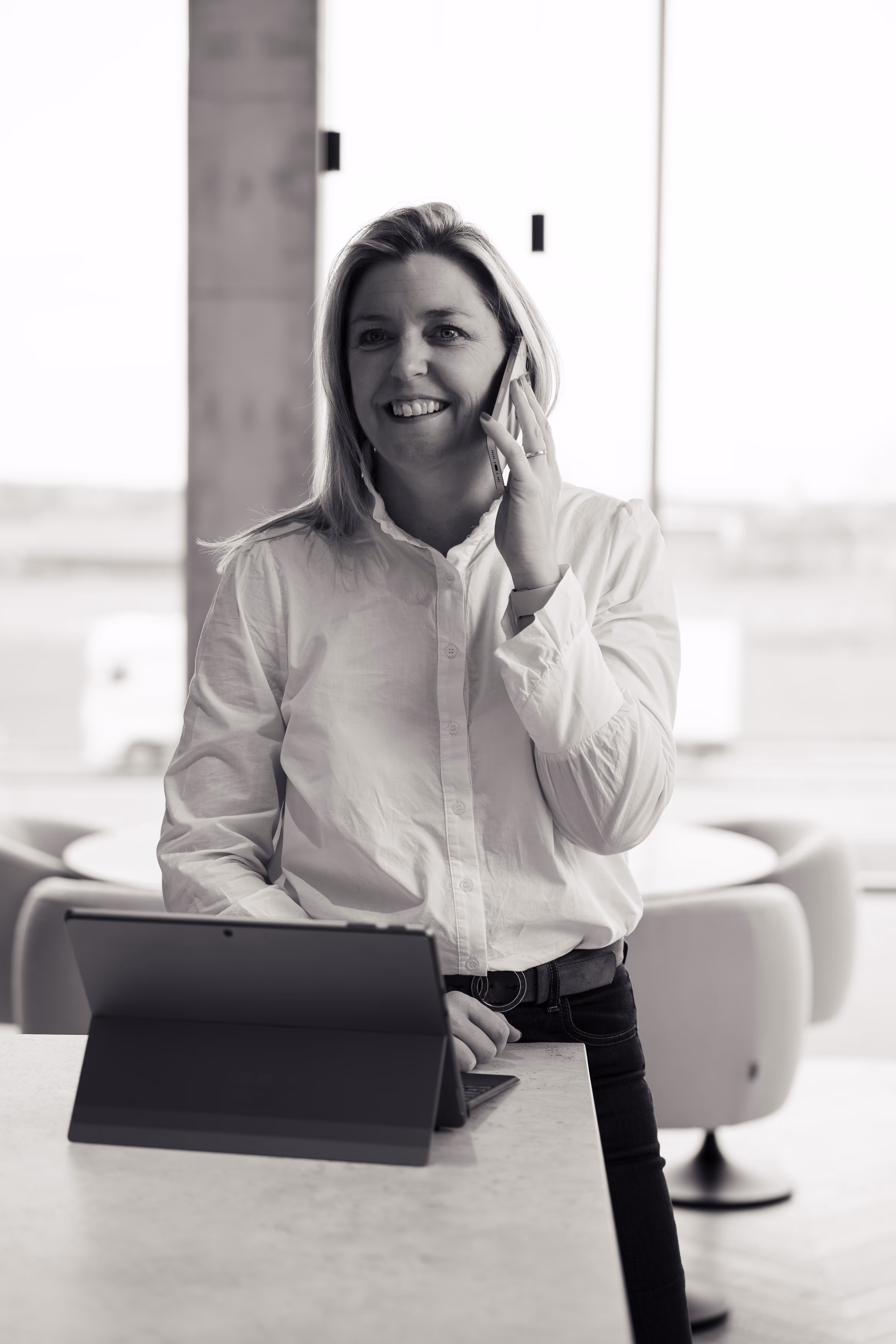 A lady standing and talking on phone