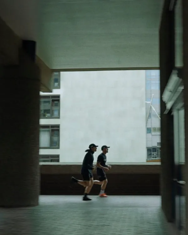 Two runners through the Barbican