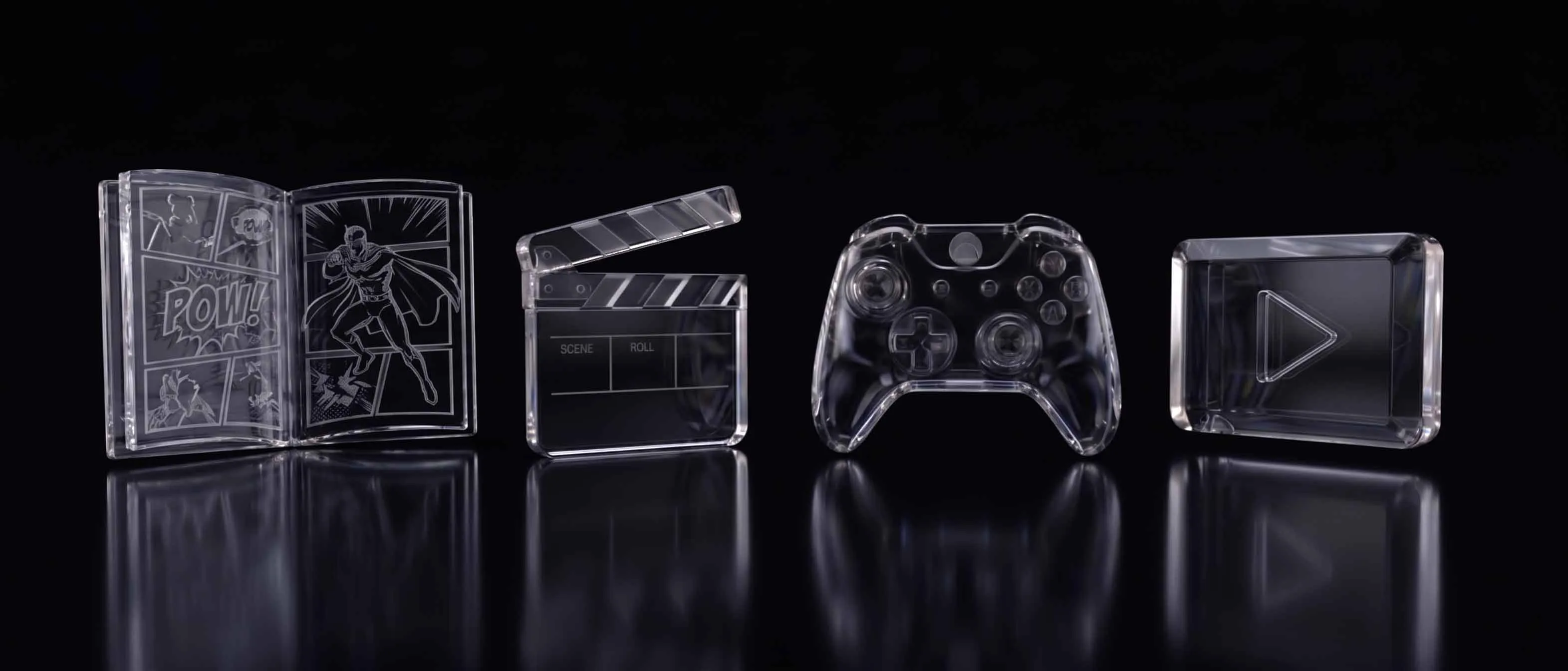 Glass icons of a comic book, film slate, game controller, and play button on a black reflective background.