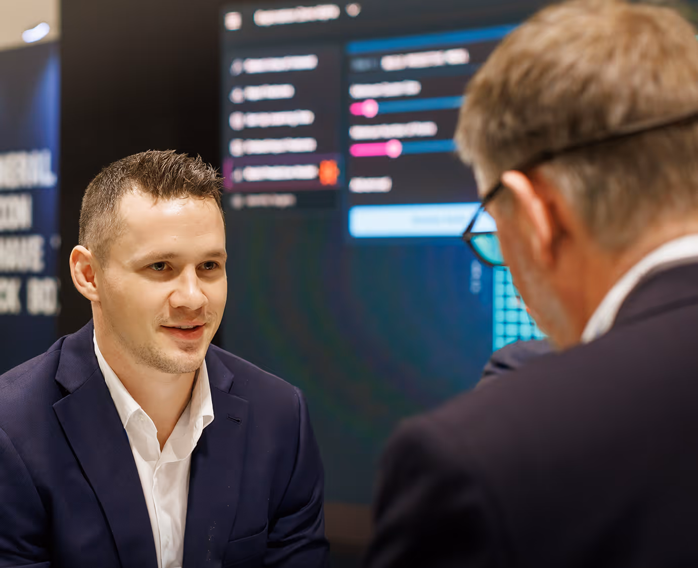 VRIFY team member speaking with a prospect at an event