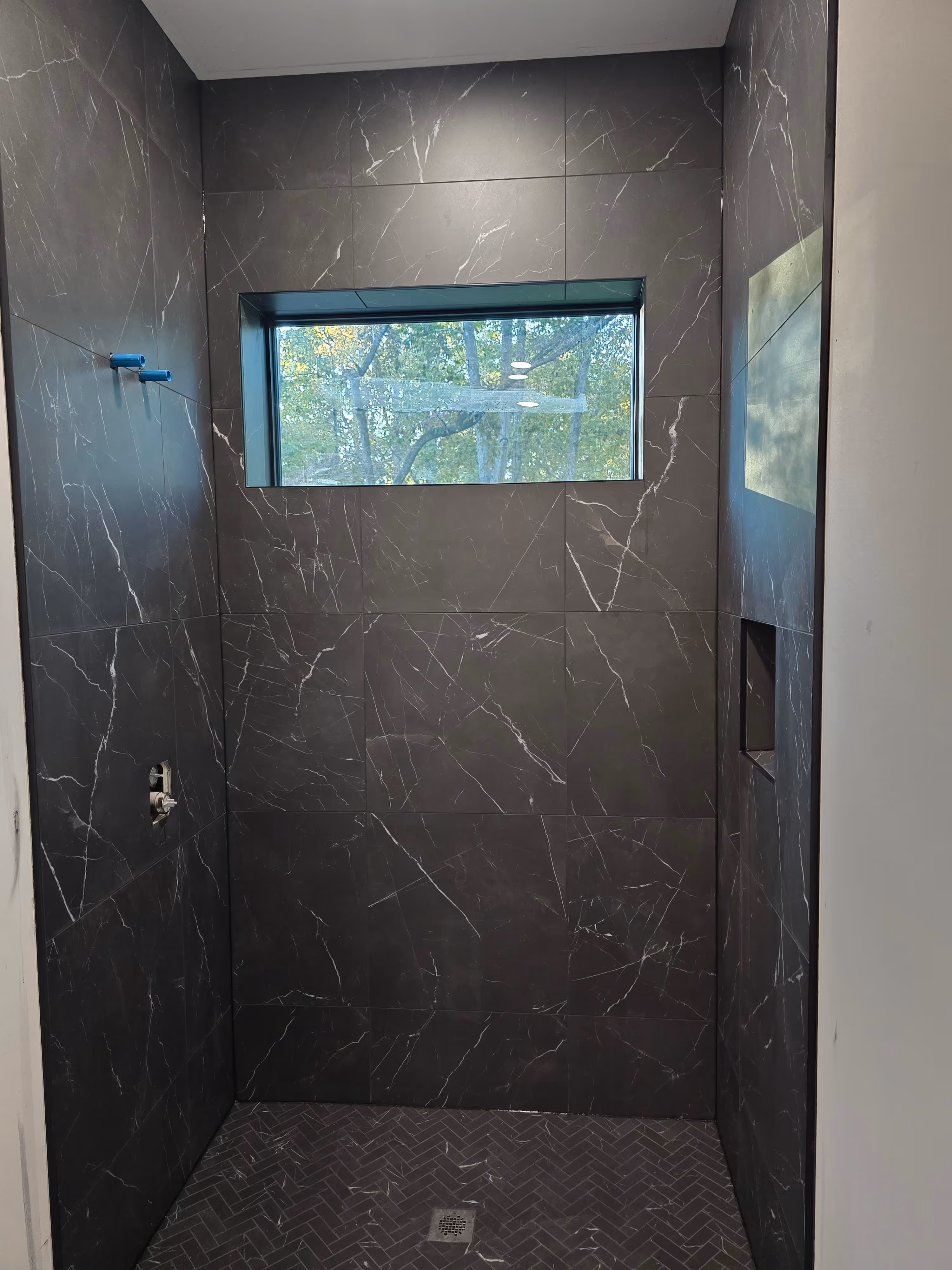 floor and walls tile work in a shower