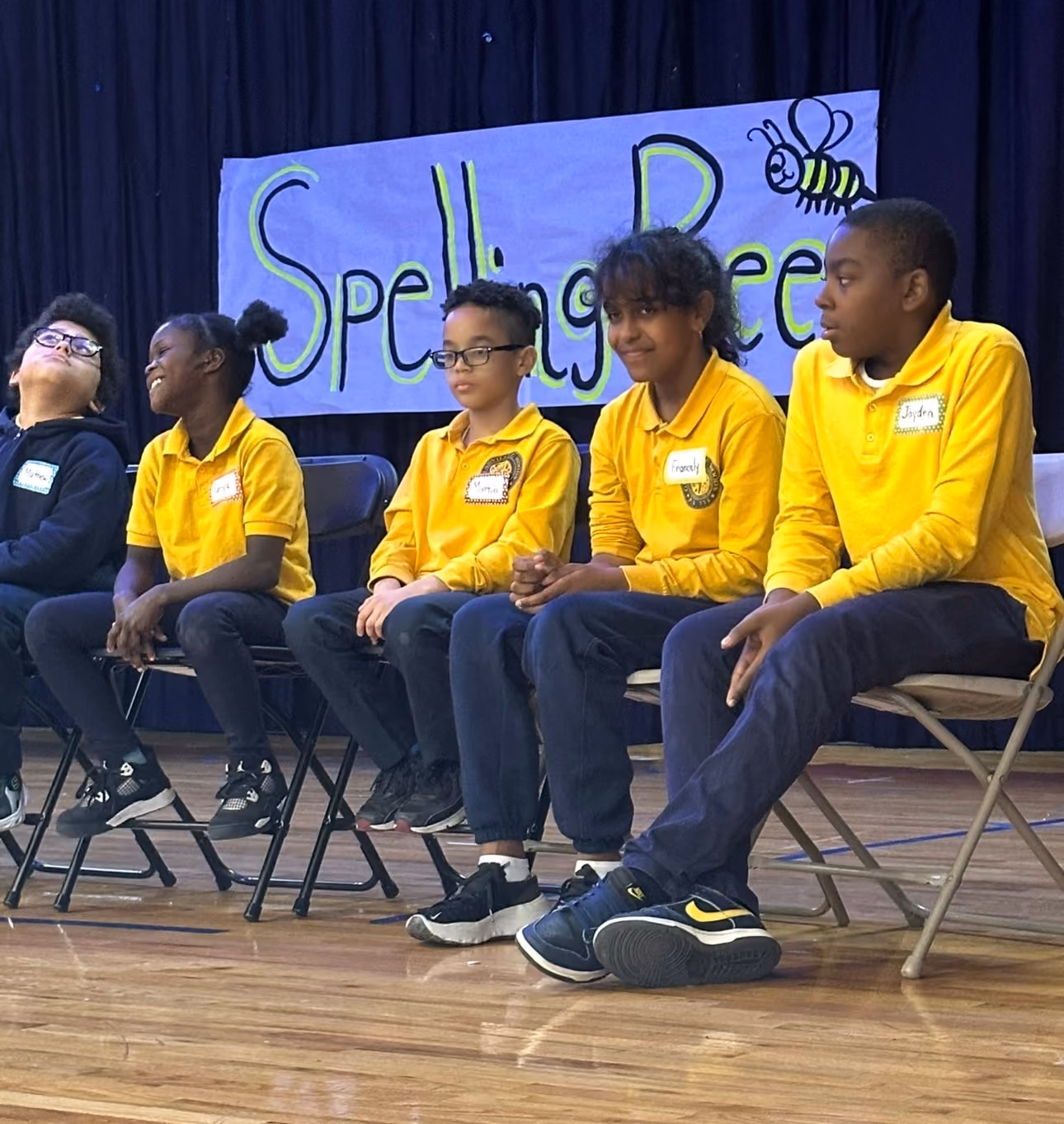 Students on stage during spelling bee event