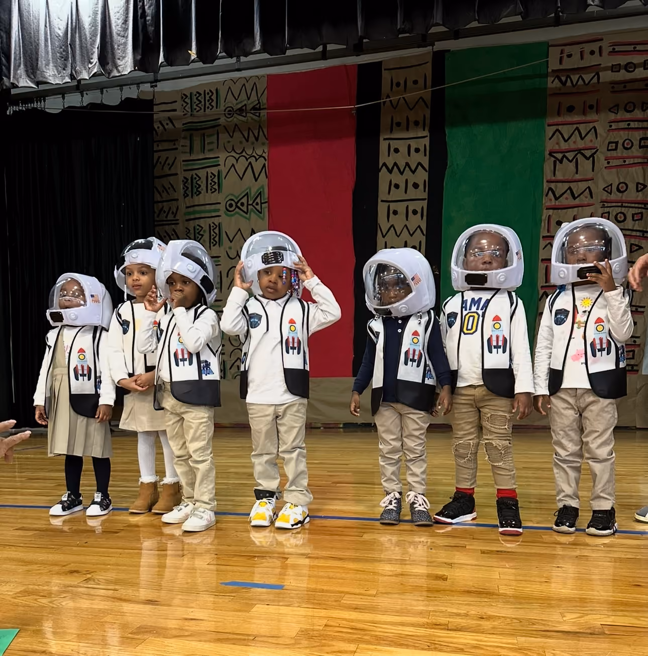 Students dressed in cultural attire performing on stage