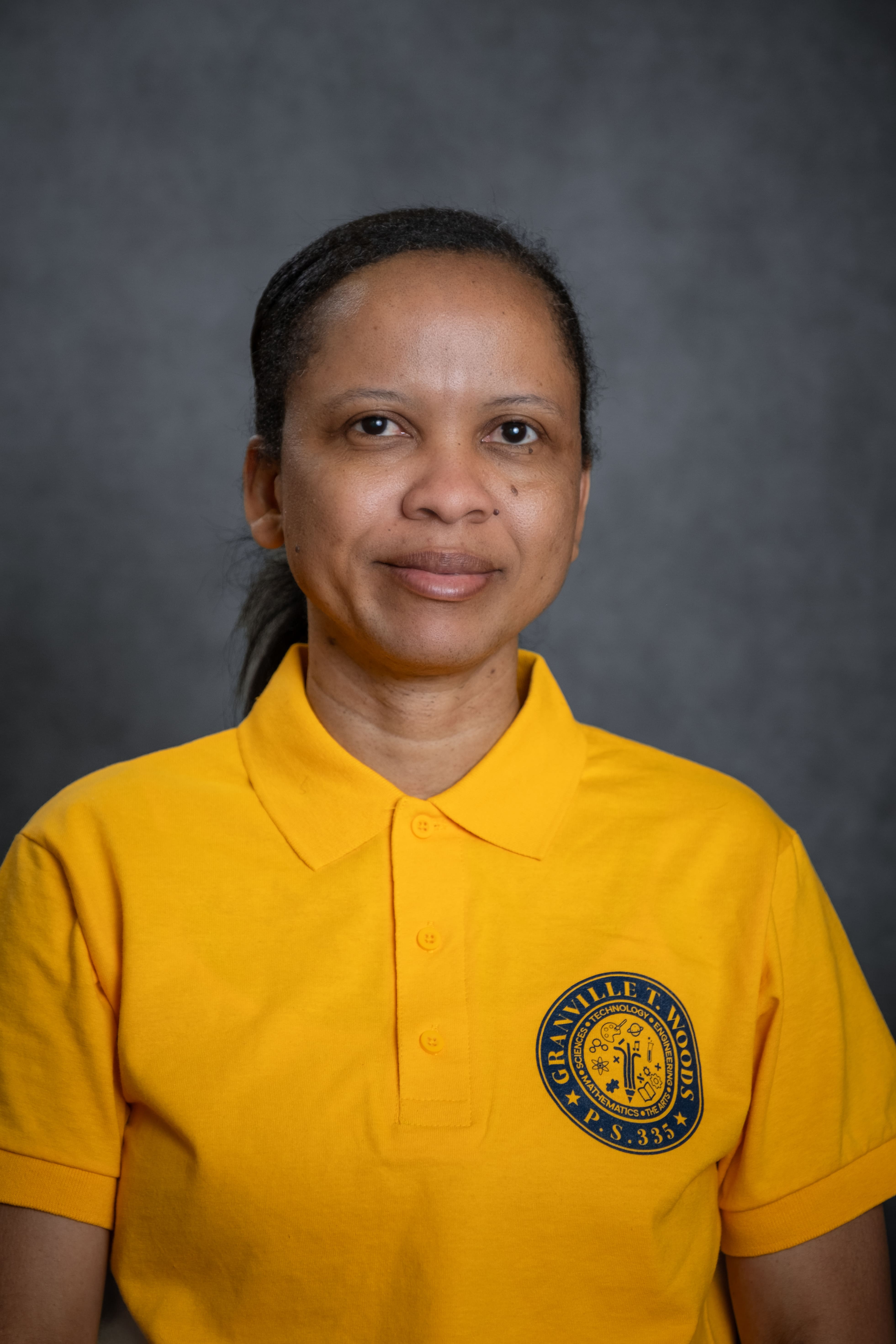 Staff member M. Herdsman in Granville T. Woods PS 335 polo shirt