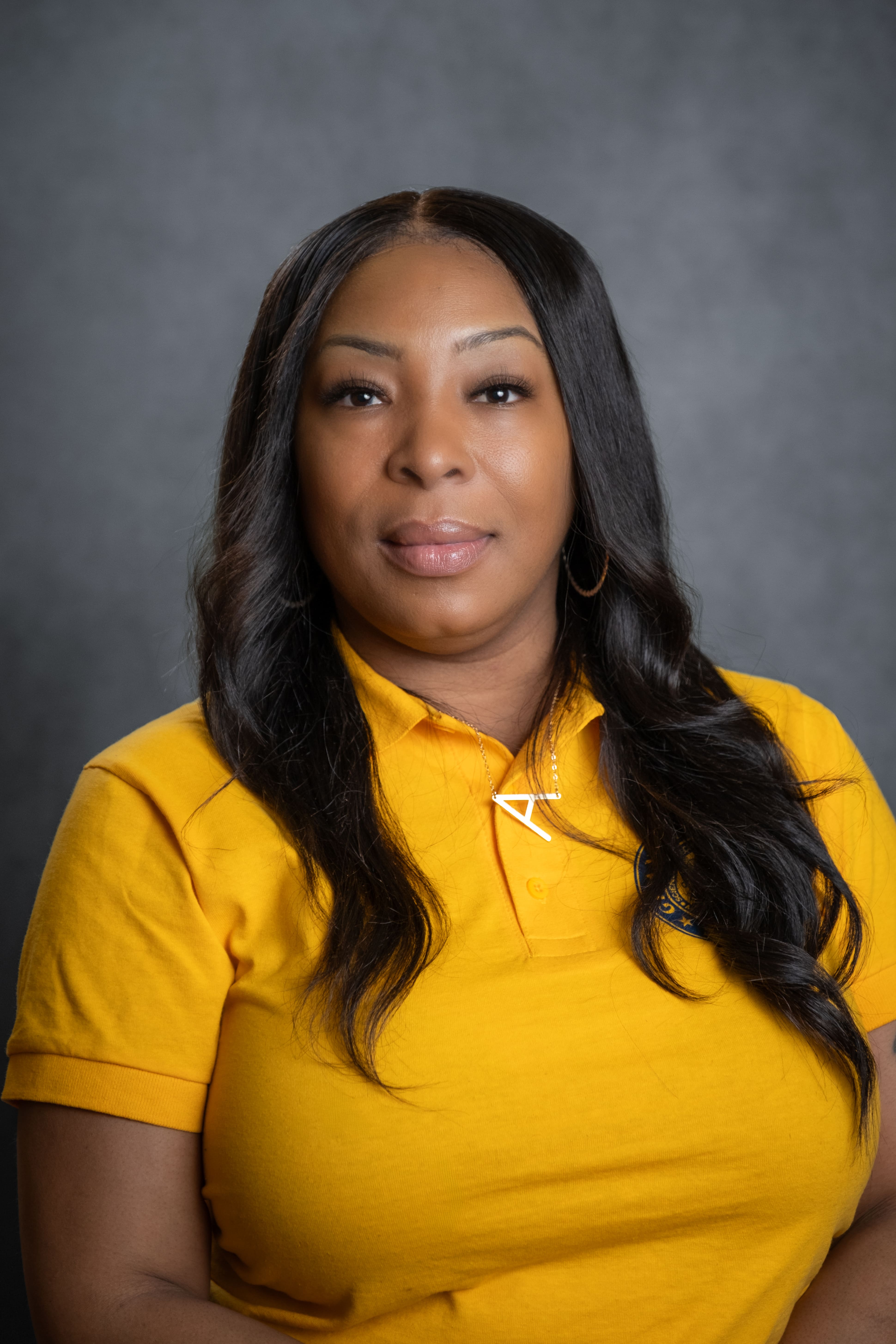 Staff member A. Joseph in yellow school polo shirt