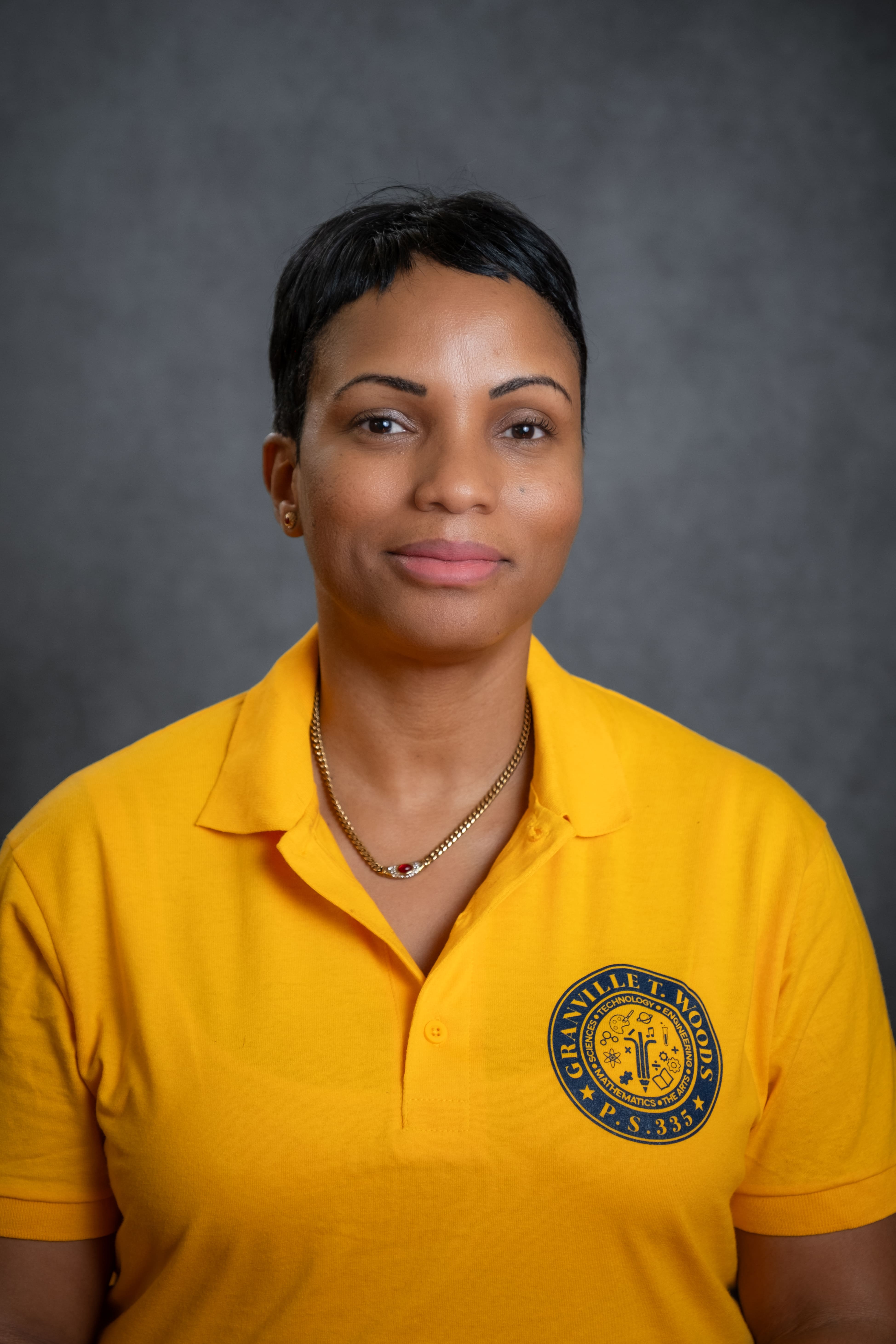 Staff member N. Campbell wearing Granville T. Woods P.S. 335 polo shirt