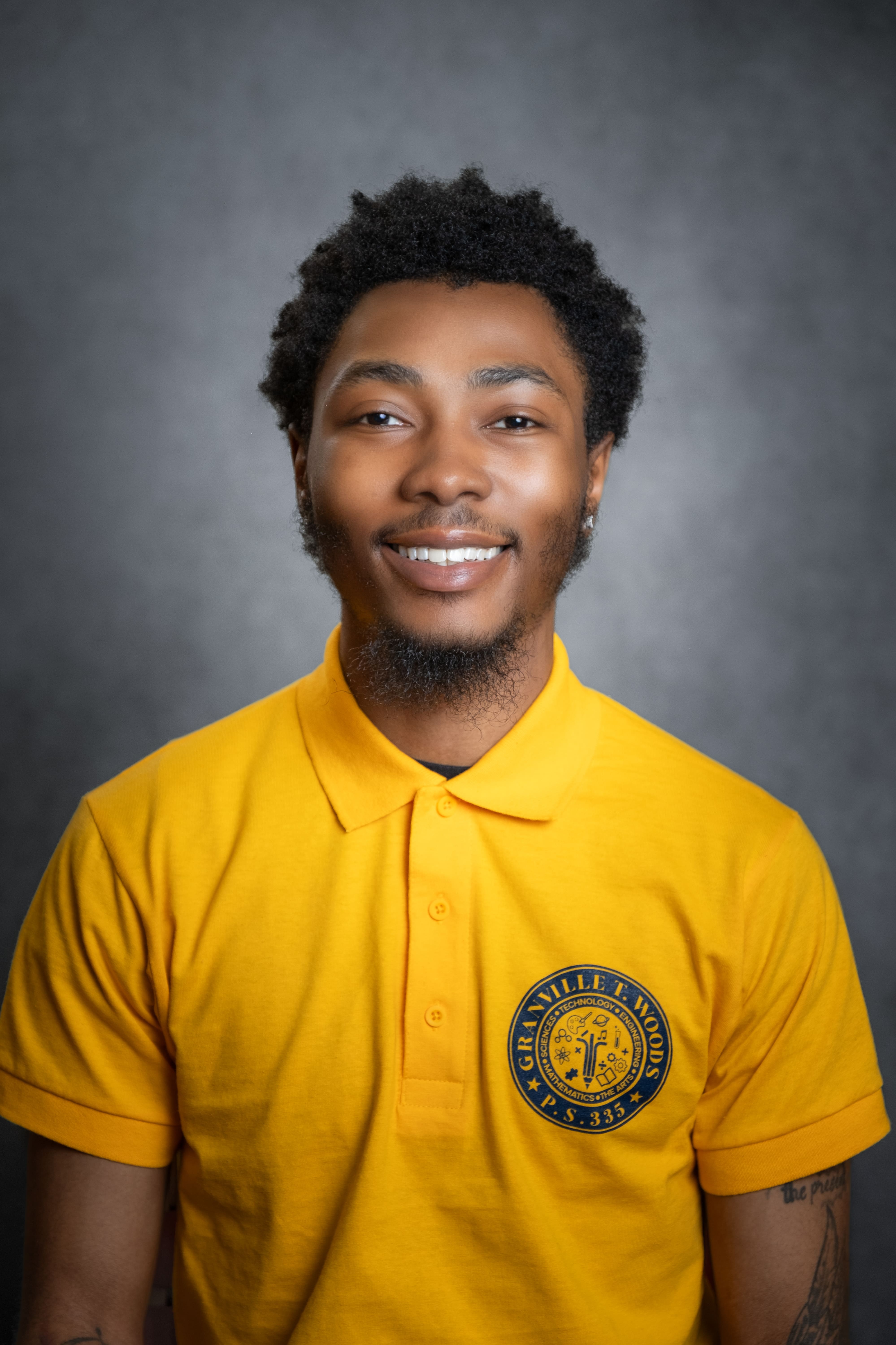 L Hodges staff portrait in Granville T Woods PS 335 polo shirt