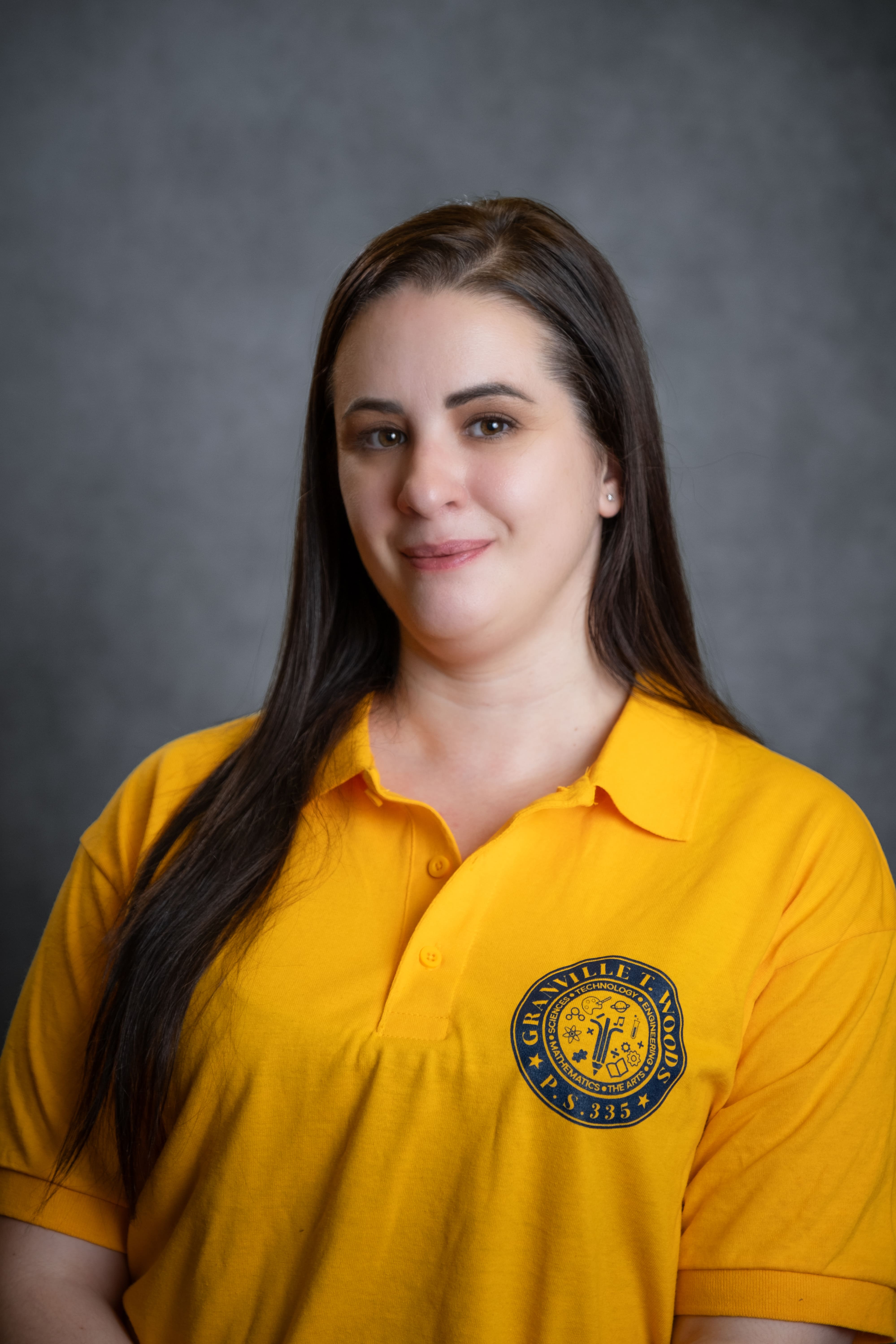 Staff member B. Cordova wearing PS 335 school polo shirt