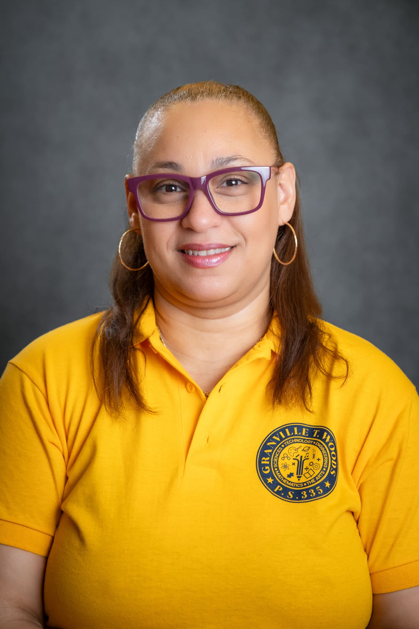 Staff member Y. Kim wearing Granville T. Woods PS 335 school polo