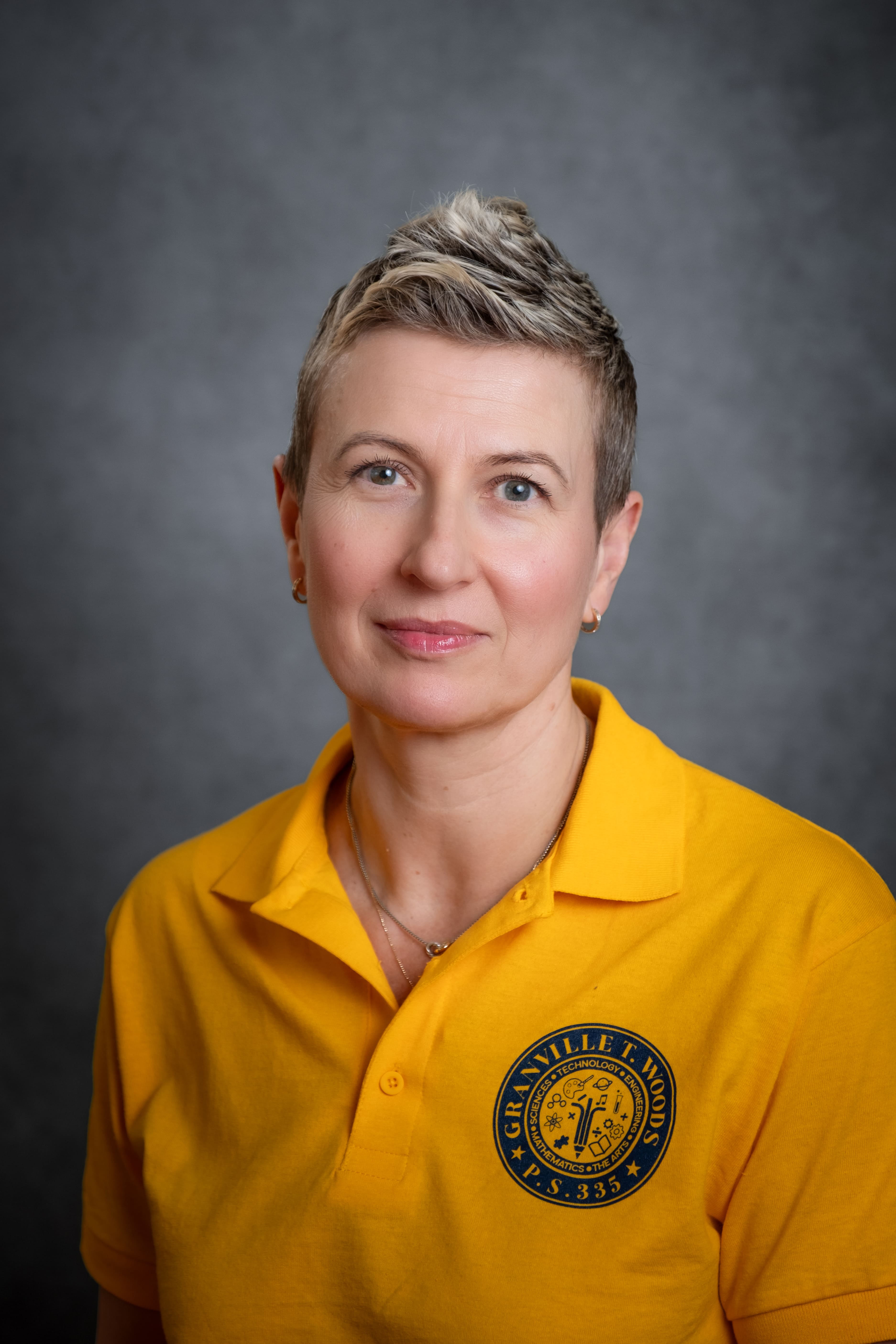 Staff member M. Mlynarczyk in PS 335 school polo shirt