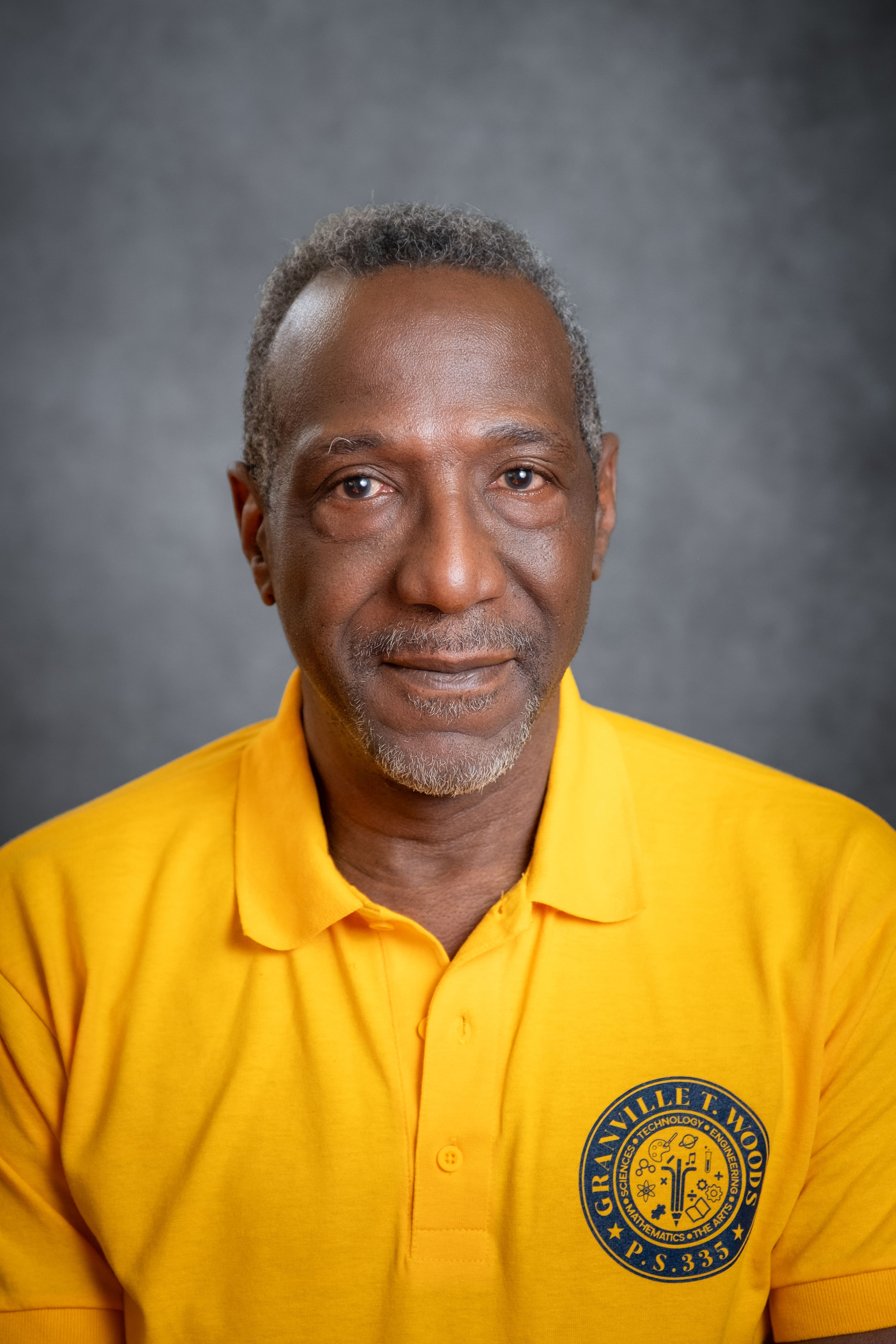 Staff member D. Minor in Granville T. Woods PS 335 polo shirt