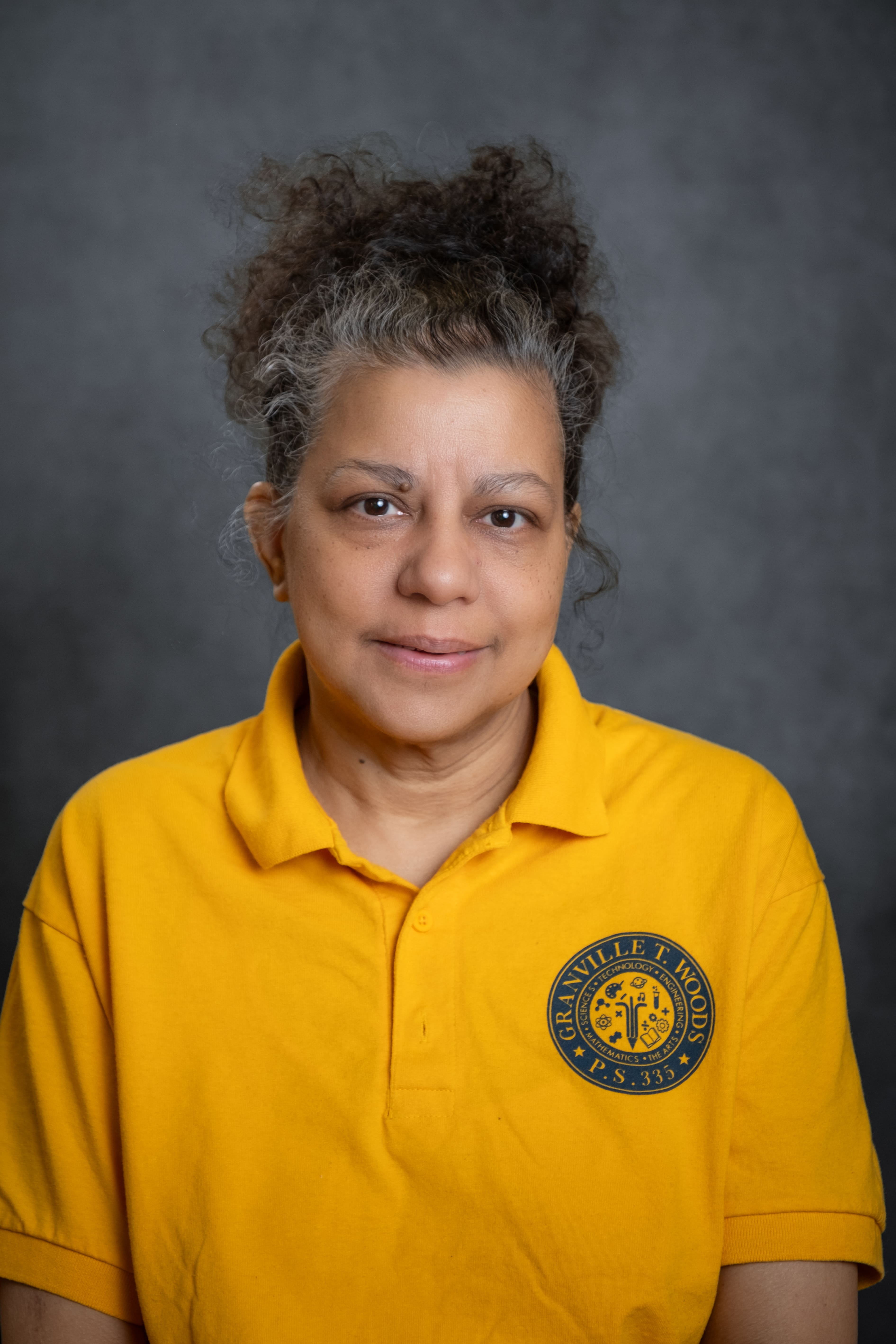 Staff member L. Zitman wearing a PS 335 school polo shirt