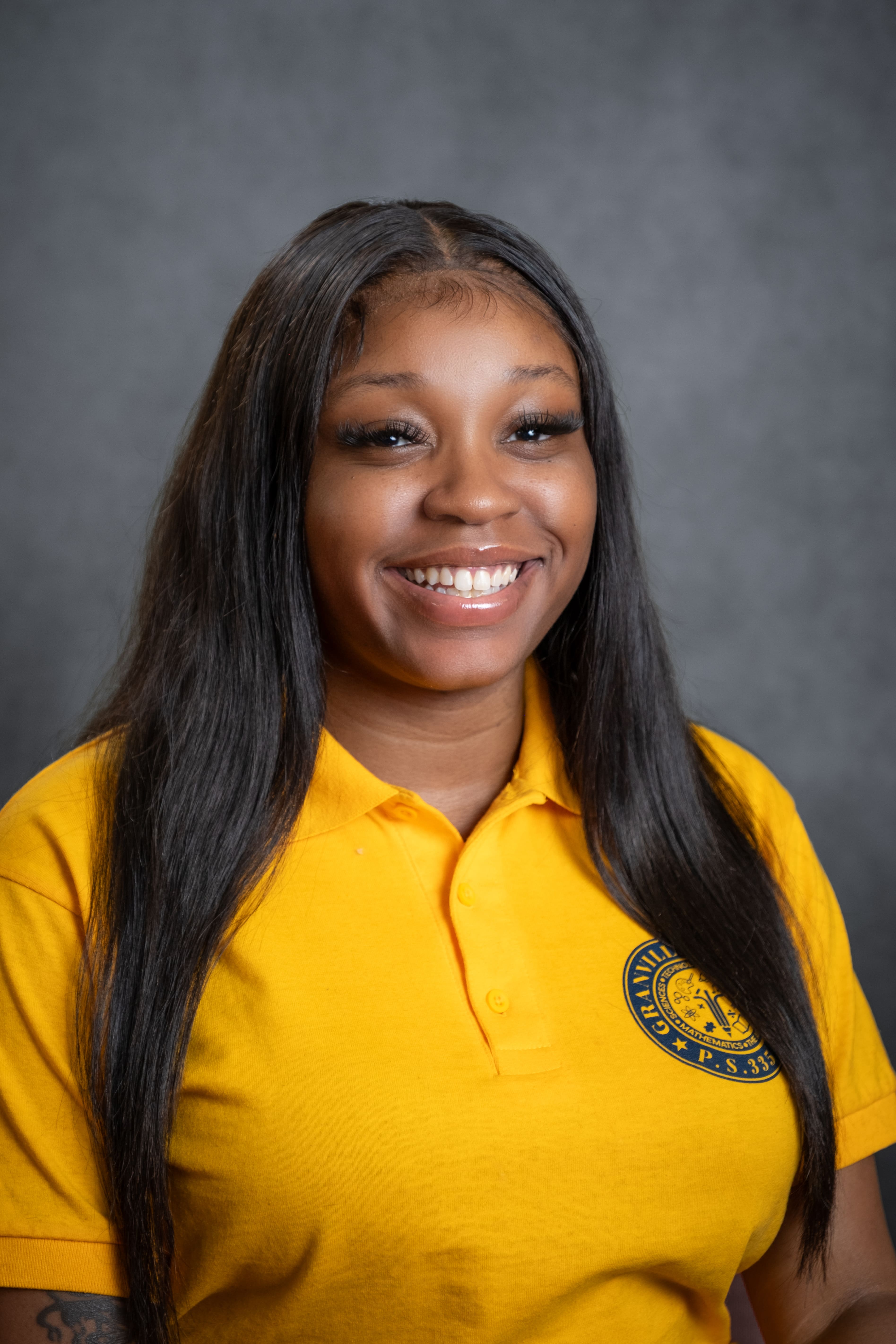 A. Barratt smiling in PS 335 gold school uniform polo