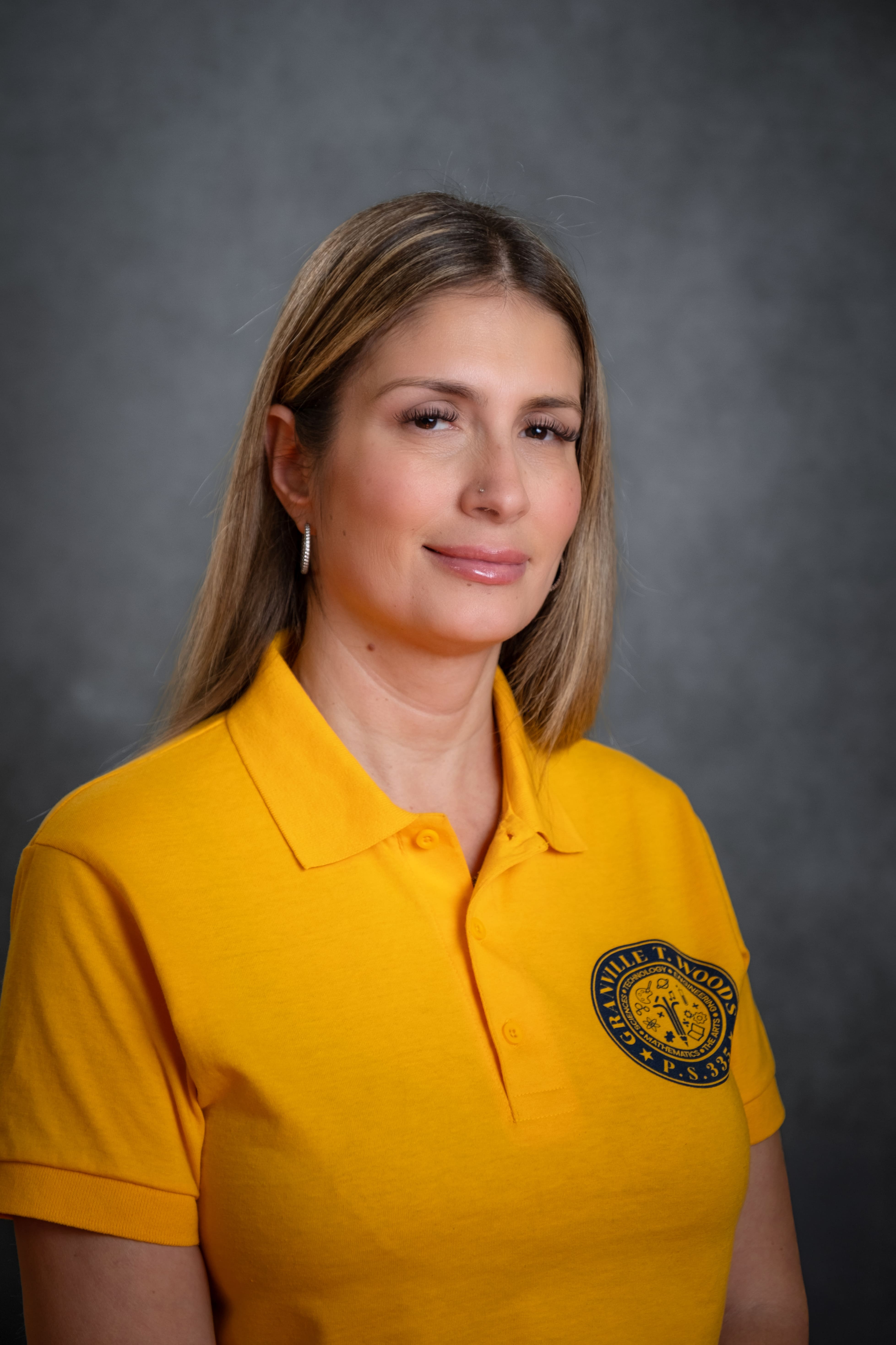 Staff member J. Montalvo in Granville T. Woods PS 335 polo shirt
