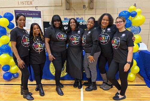 Seven Team Early Childhood staff members posing together at school event
