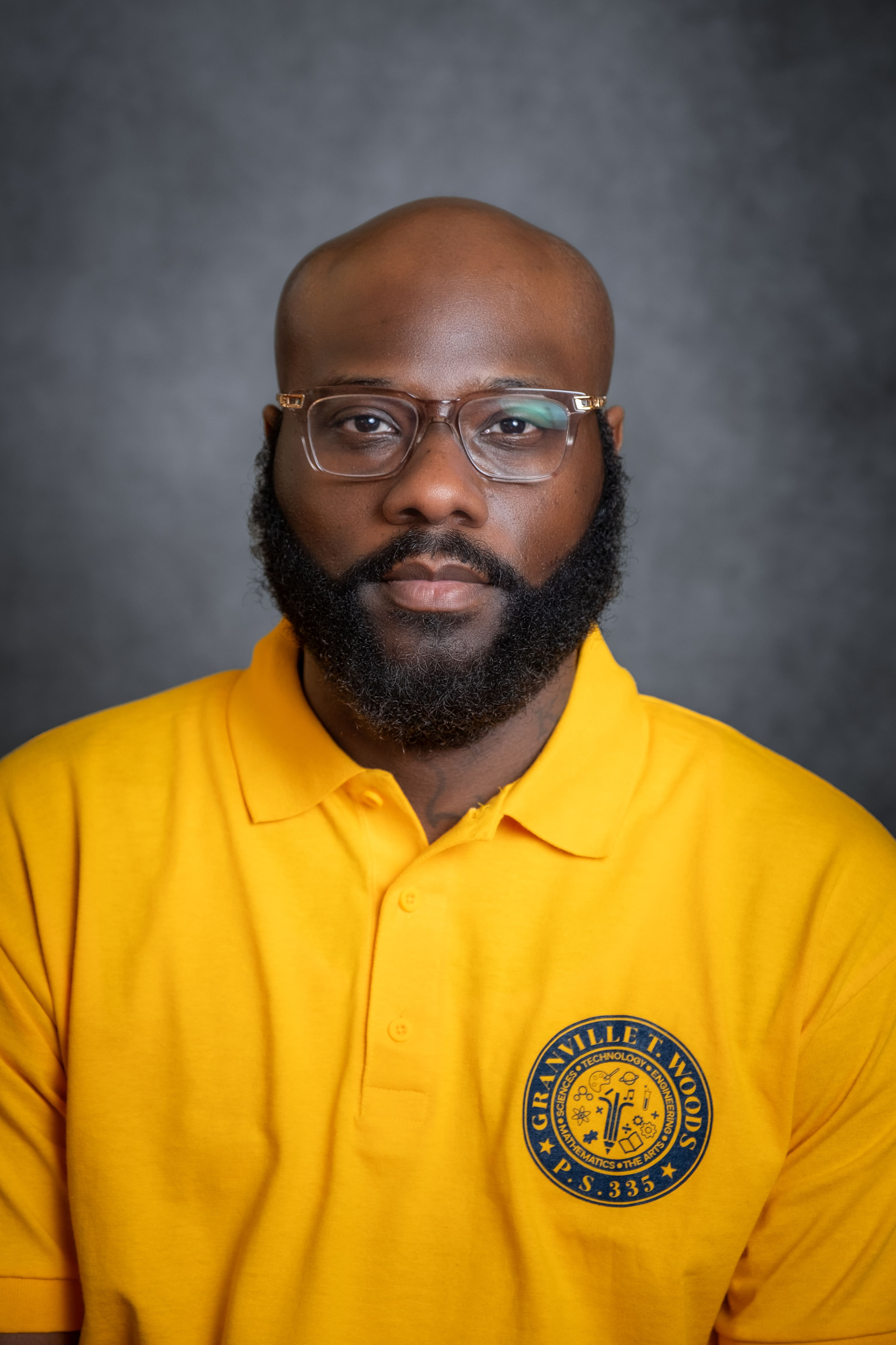 Staff member K. Alcindor in Granville T. Woods P.S. 335 school shirt