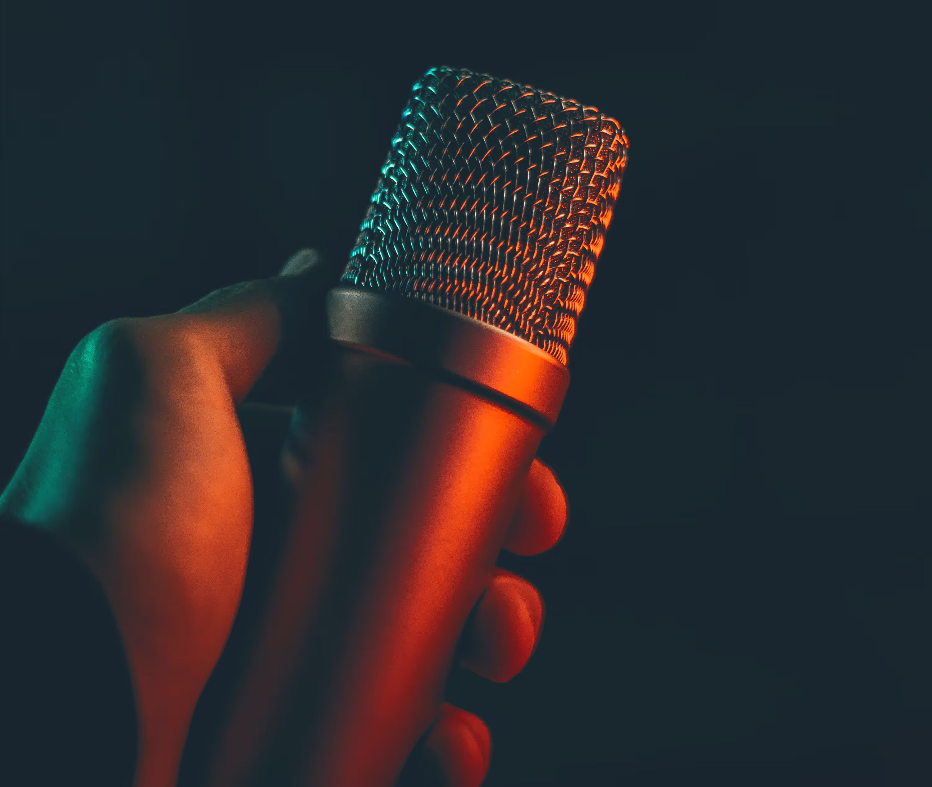 A Orange duotone microphone in a hand