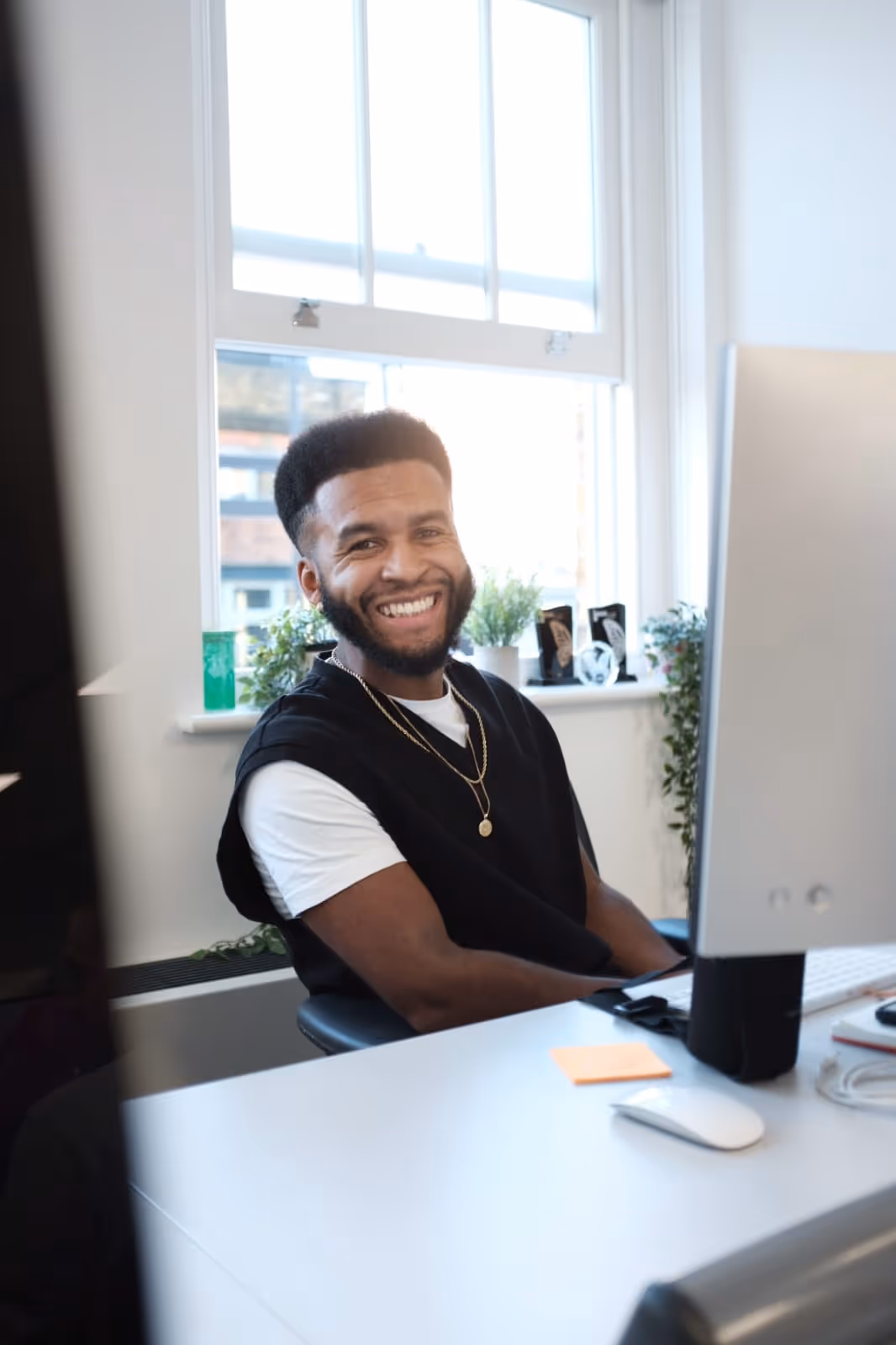 A picture of Nathanael Johnson at a desk with the sun shining behind him in the background