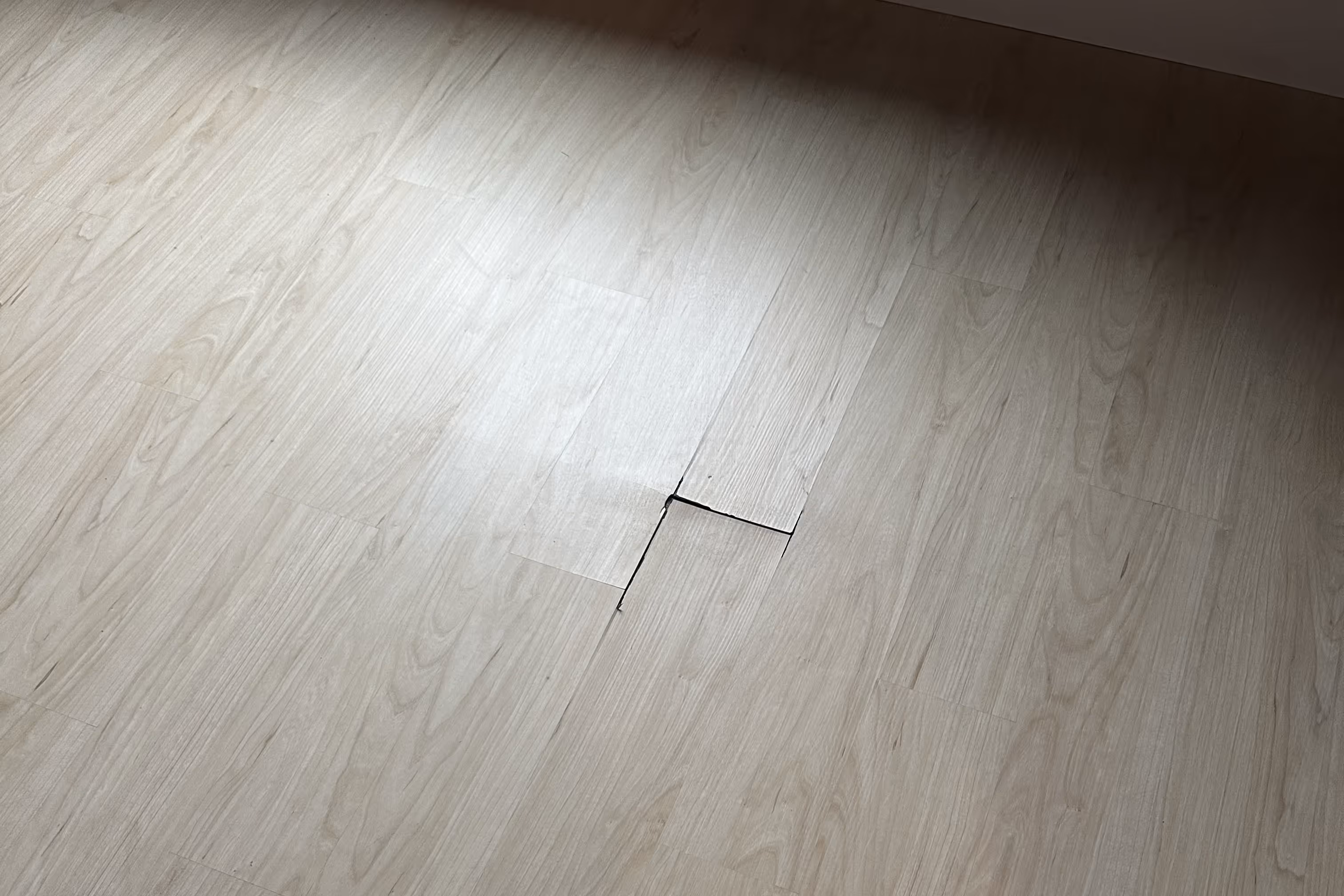 a poorly installed floor a visible bumps and plank separation