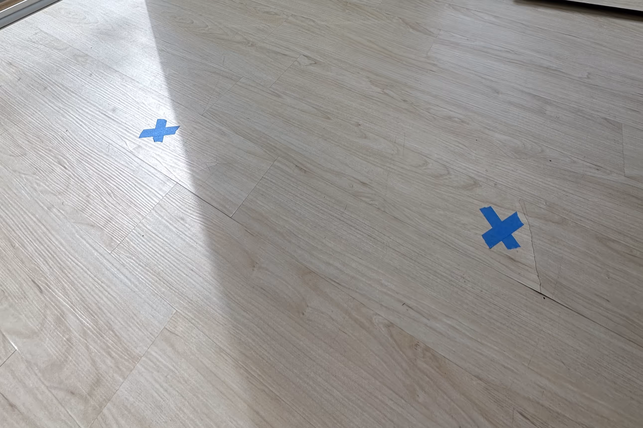 a poorly installed floor with many visible bumps and plank separation