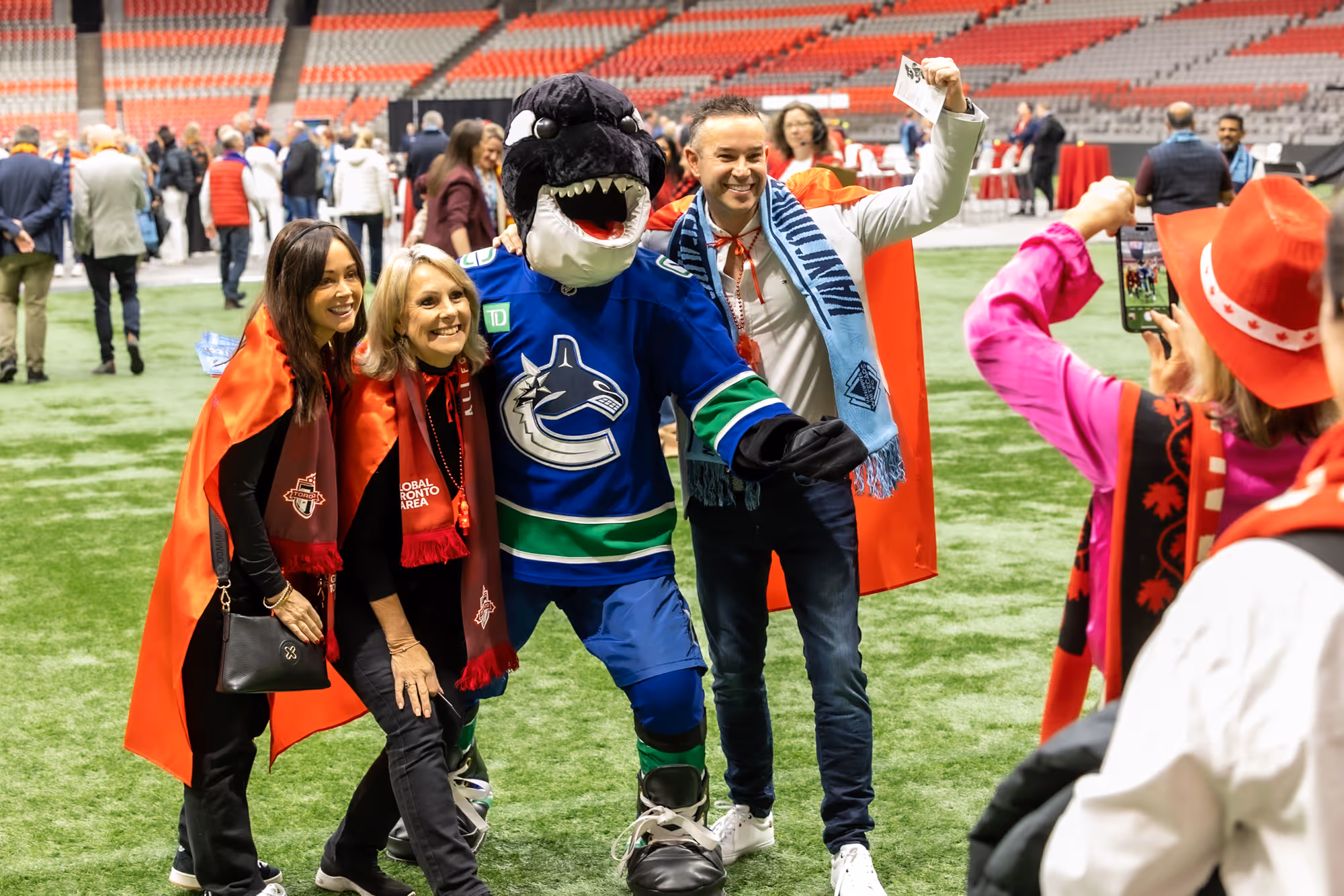 Crowd taking pictures at a sports event in Vancouver