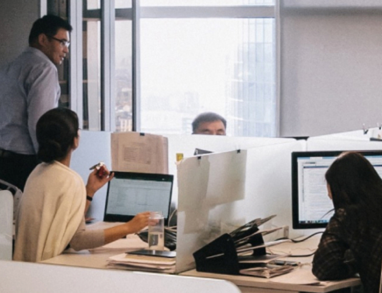 a group of people working on computers in an office