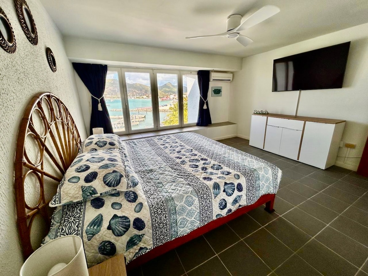 King bedroom with dresser and TV
