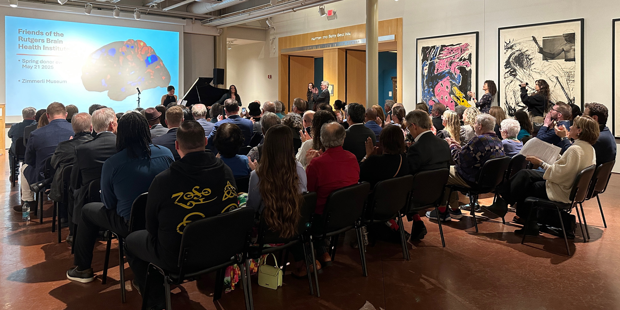 Audience applauding the performance during the BHI & Friends event