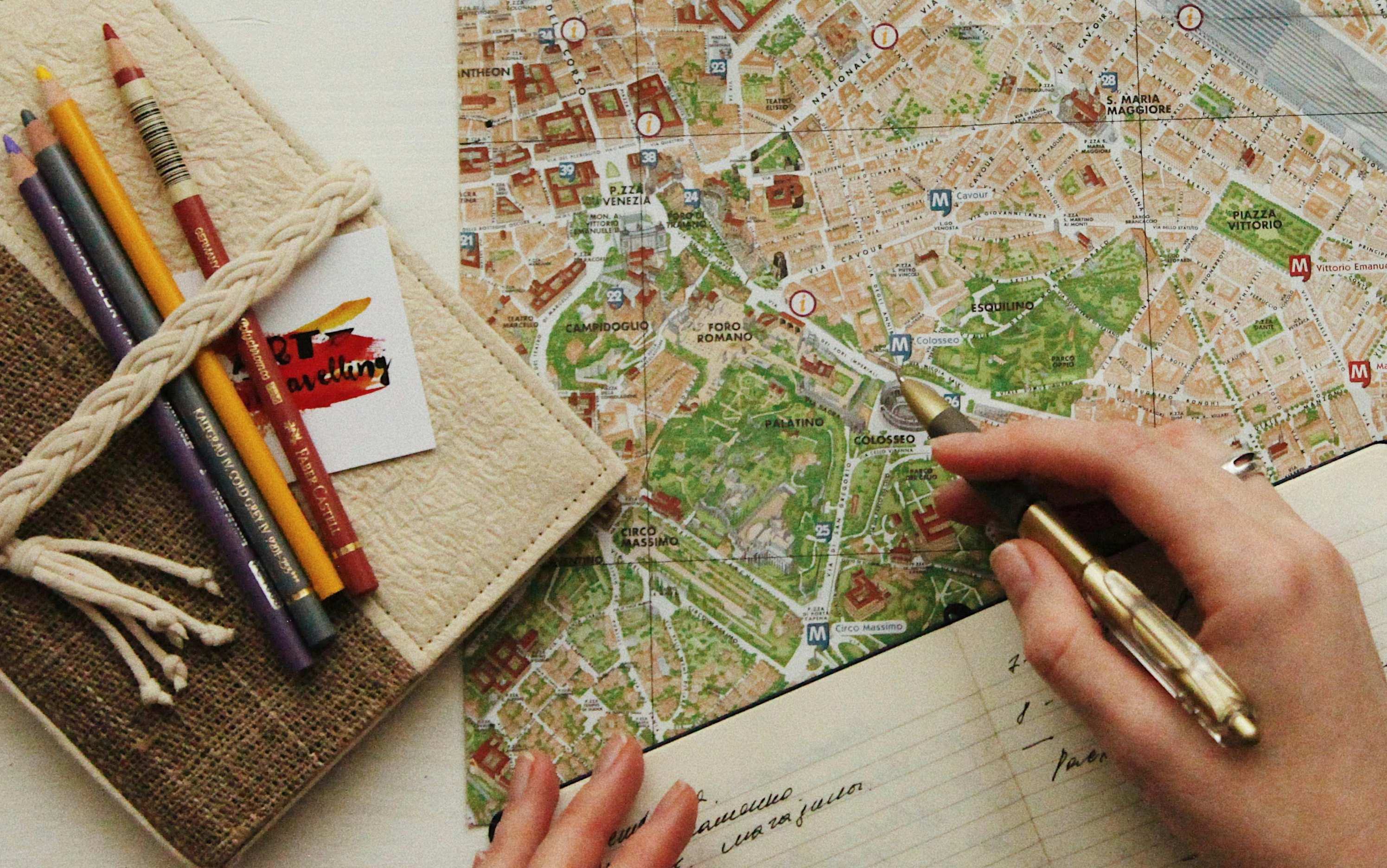 map with notebook and hands with pen