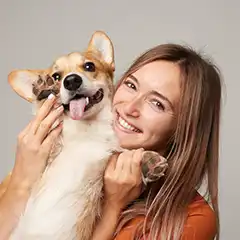 a spot customer support representative holding a dog in her arms
