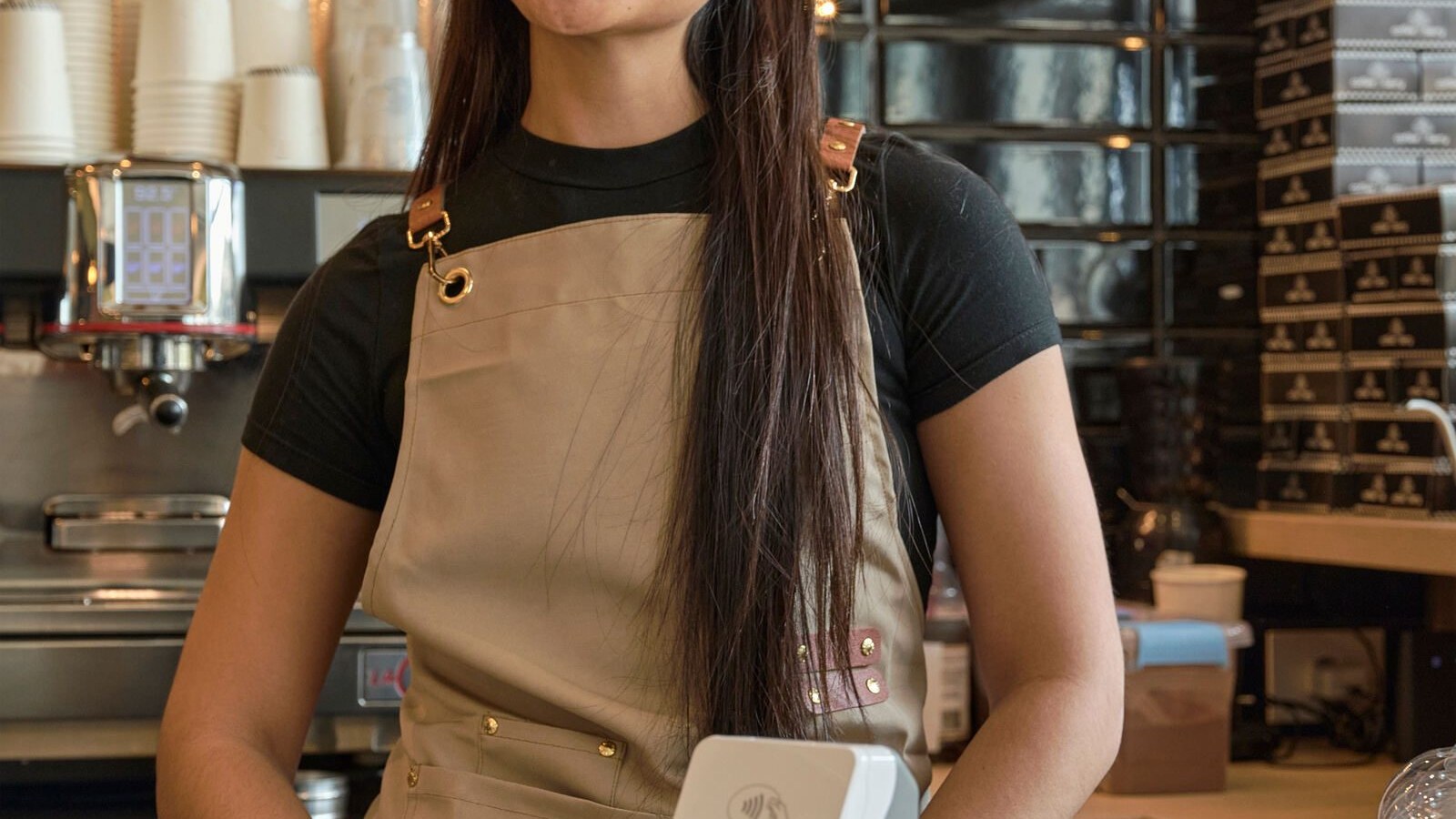 Cafe worker holding a smart payment terminal
