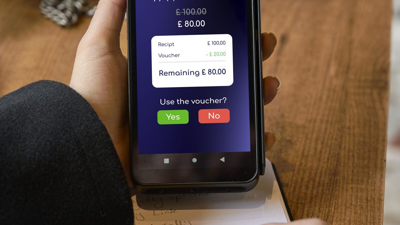 Customer applying a voucher on a payment terminal at checkout