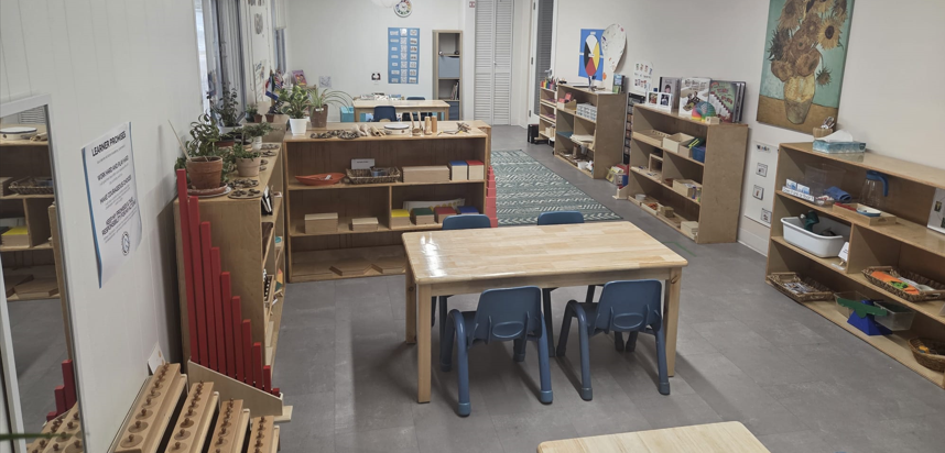 A mom and dad walking with their daughter along a treed path