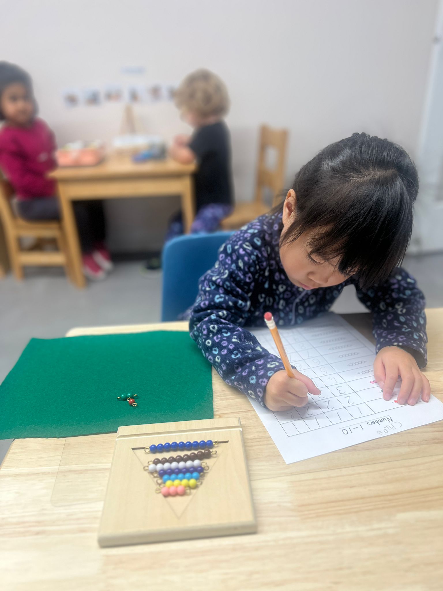 2 students smiling and looking at a computer screen
