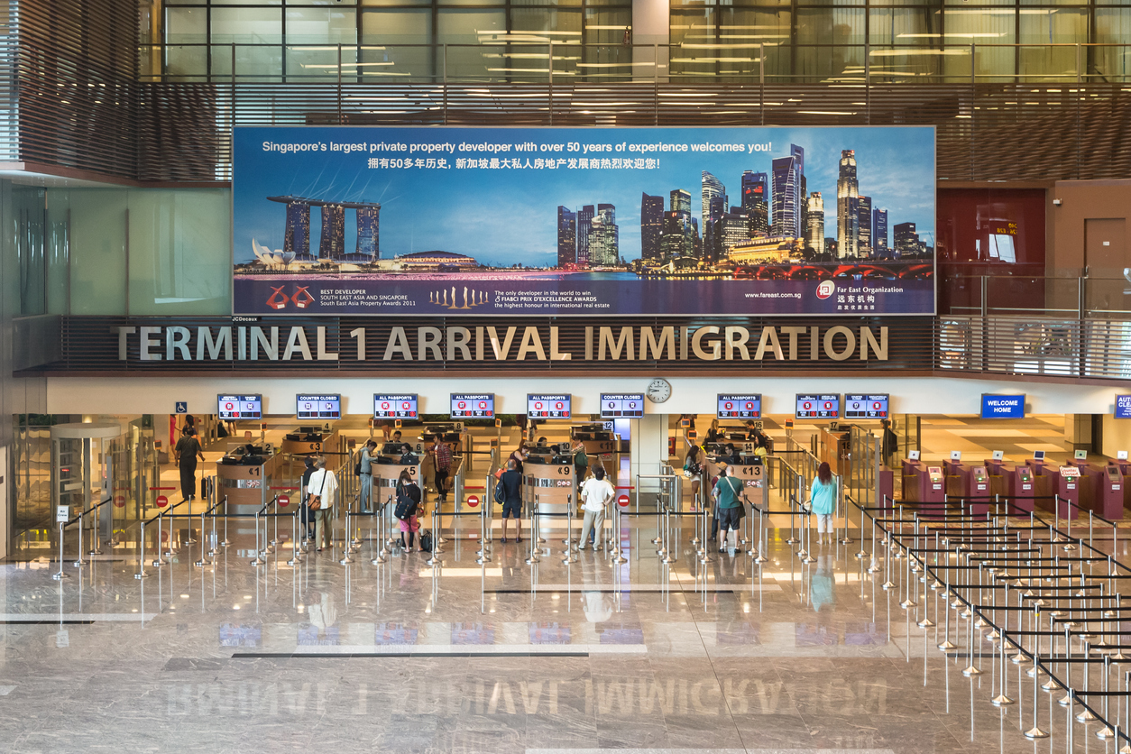 Travellers at Singapore Changi Airport, symbolising new procedures for Permanent Resident Re-Entry Permit (REP) applications effective December 2025.